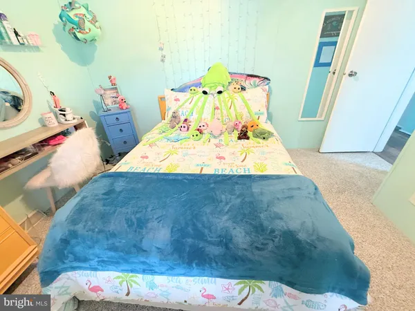 a bedroom with a bed and dresser