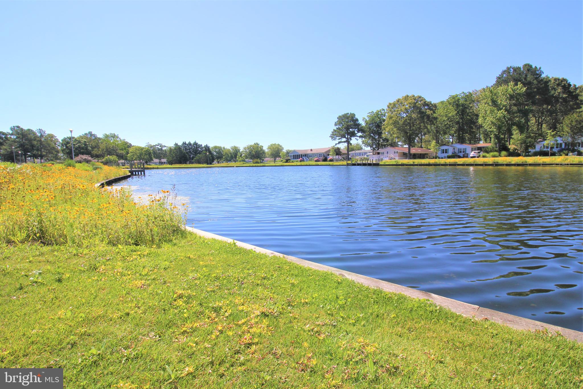 34488 Easy Street, Unit E810 Long Neck, DE 19966 - Photo 48 of 55 a view of a lake with houses in the back