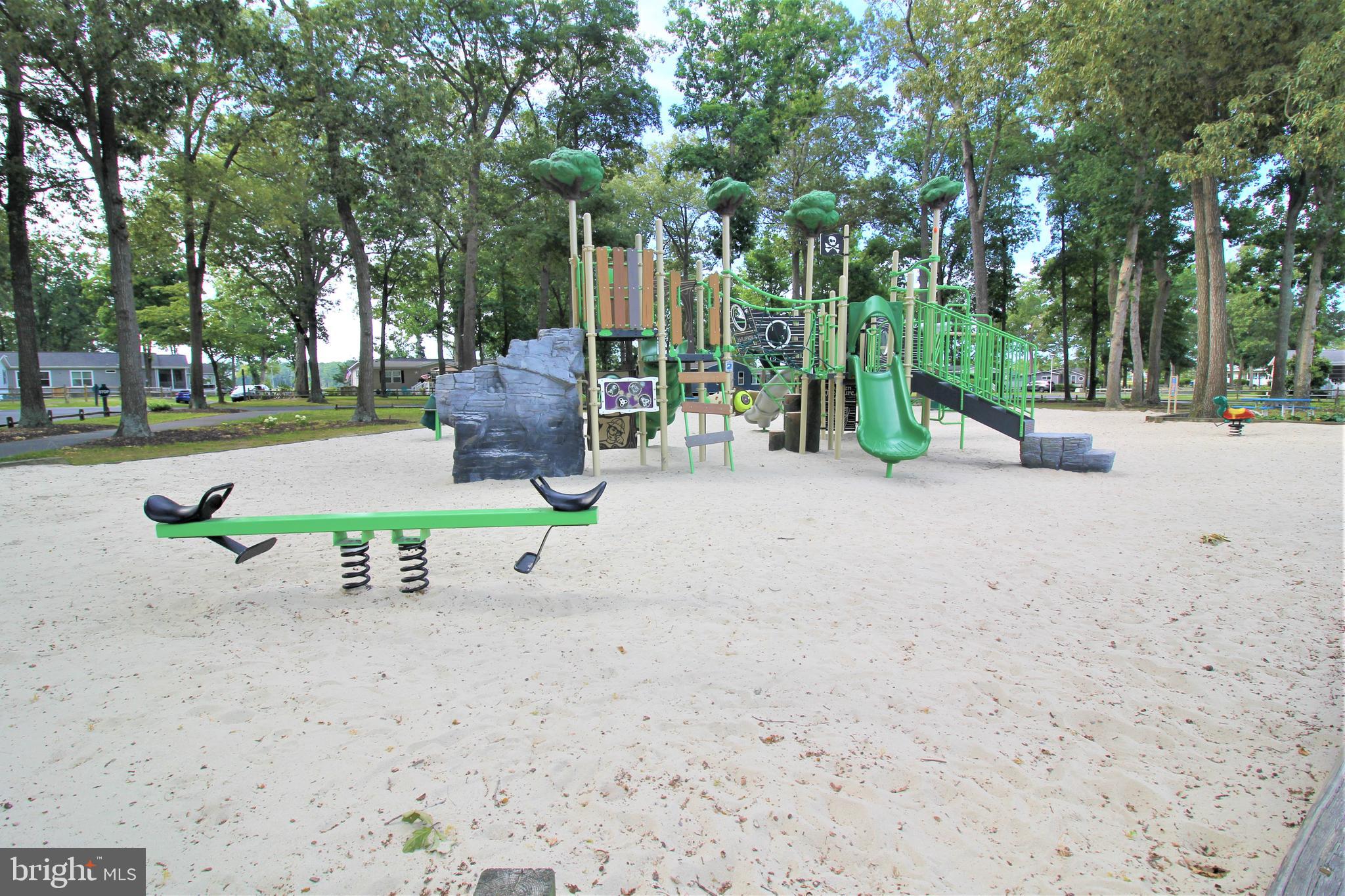 34488 Easy Street, Unit E810 Long Neck, DE 19966 - Photo 55 of 55 a view of a park with large trees and table and chairs