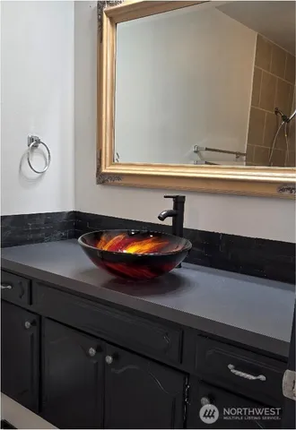 a bathroom with a sink and a mirror