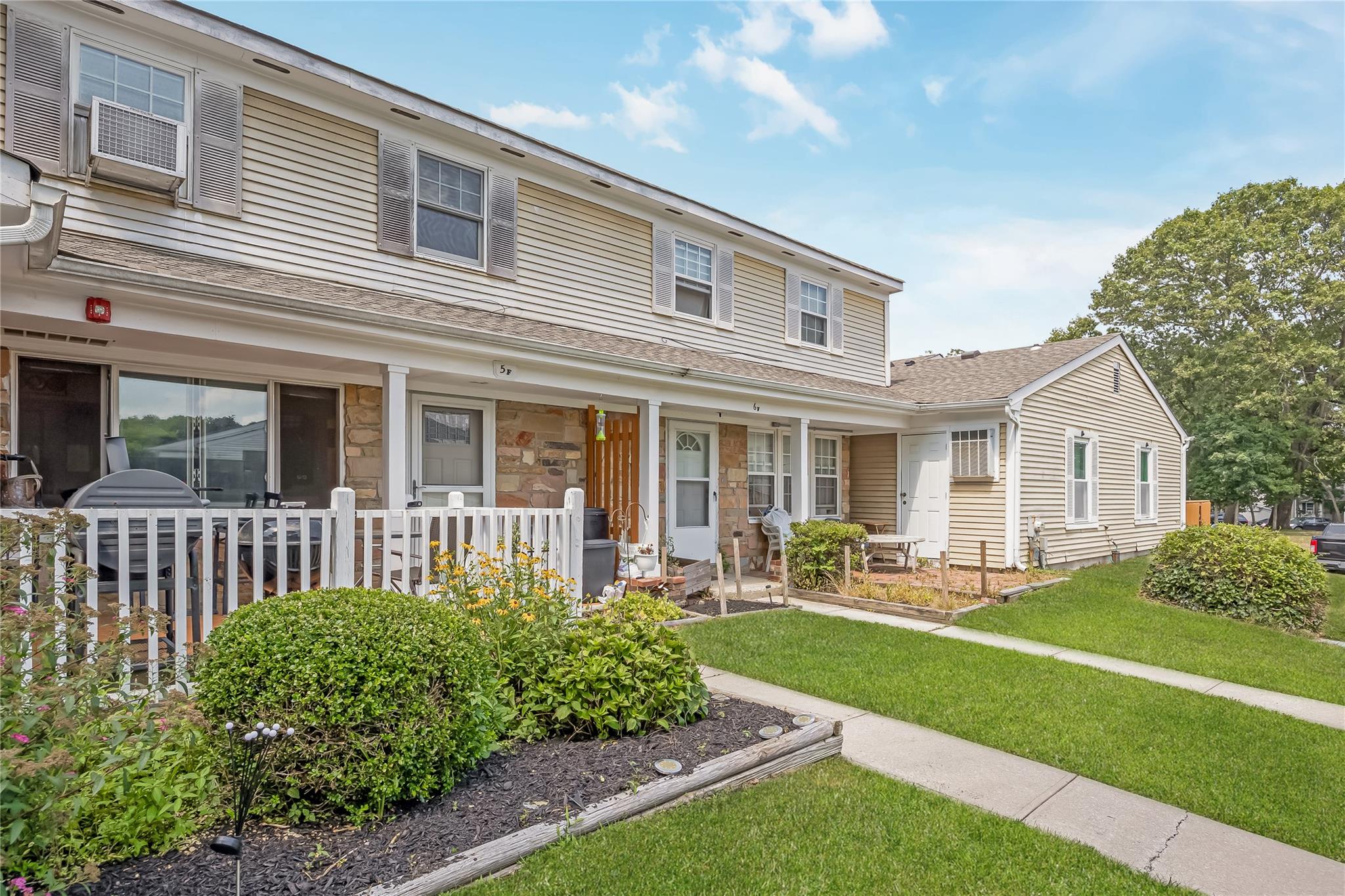 5 F Valley Forge Court Ridge, NY 11961 - Photo 1 of 1 a front view of a house with a yard