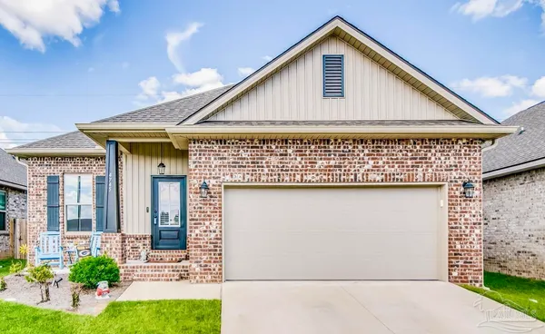 a view of a house with wooden walls and garden