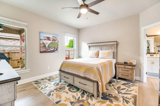 a bedroom with a bed and wooden floor
