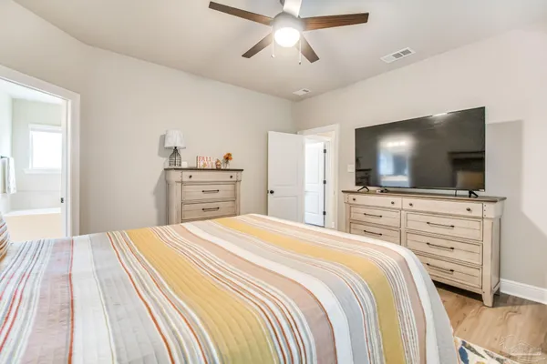 a spacious bathroom with a granite countertop sink mirror and a bathtub