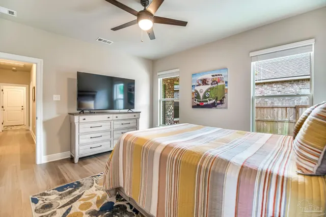 a bedroom with a bed and a flat screen tv