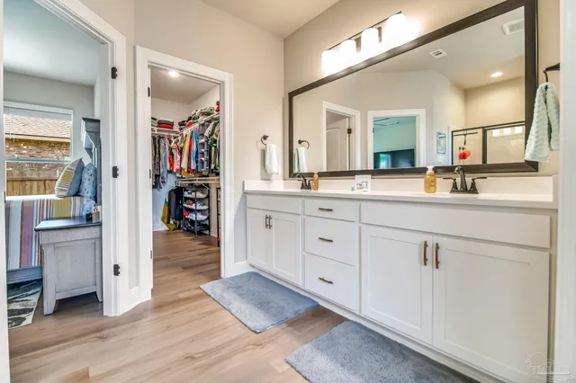 a spacious bathroom with a sink double vanity and a mirror