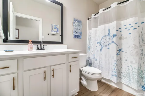 a bathroom with a sink toilet tub and shower