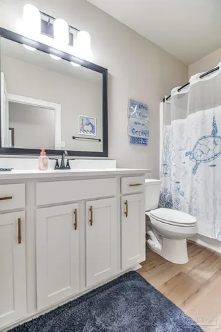 a bathroom with a toilet a sink and a mirror
