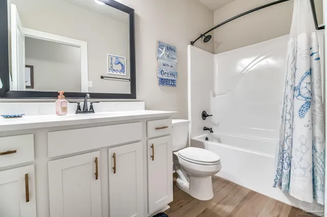 a bathroom with a sink toilet tub and shower