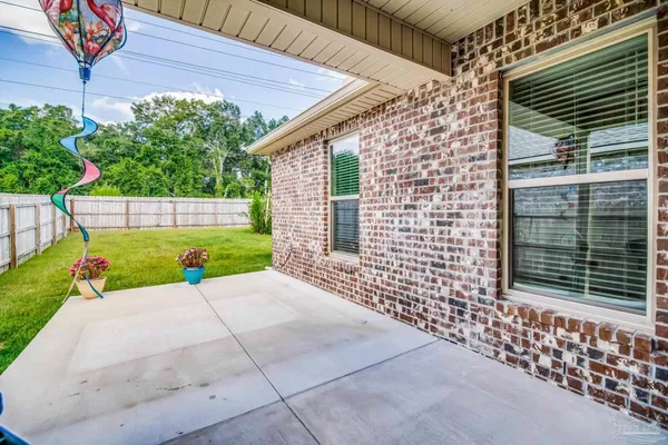 a view of an house with backyard space and balcony