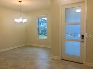 an empty room with windows mirror and closet