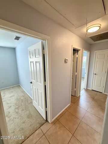 a view of a hallway to rooms