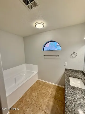 a bathroom with a granite countertop sink a mirror and a shower