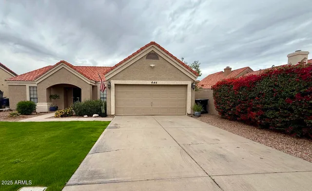 a front view of a house with a yard and garage