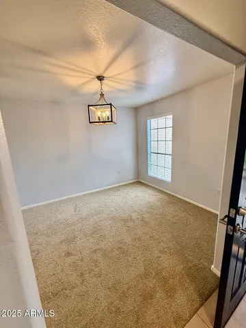 an empty room with windows and ceiling fan view
