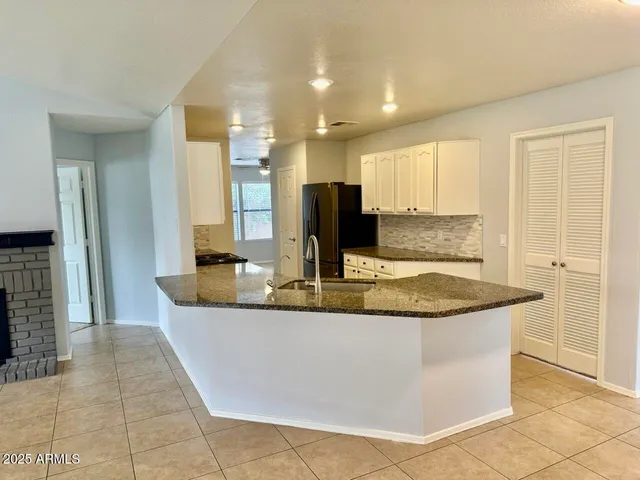 a view of kitchen with stainless steel appliances granite countertop sink
