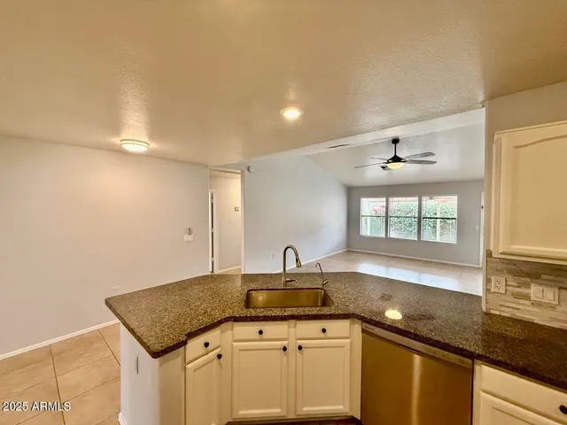 a kitchen with a sink dishwasher and cabinets