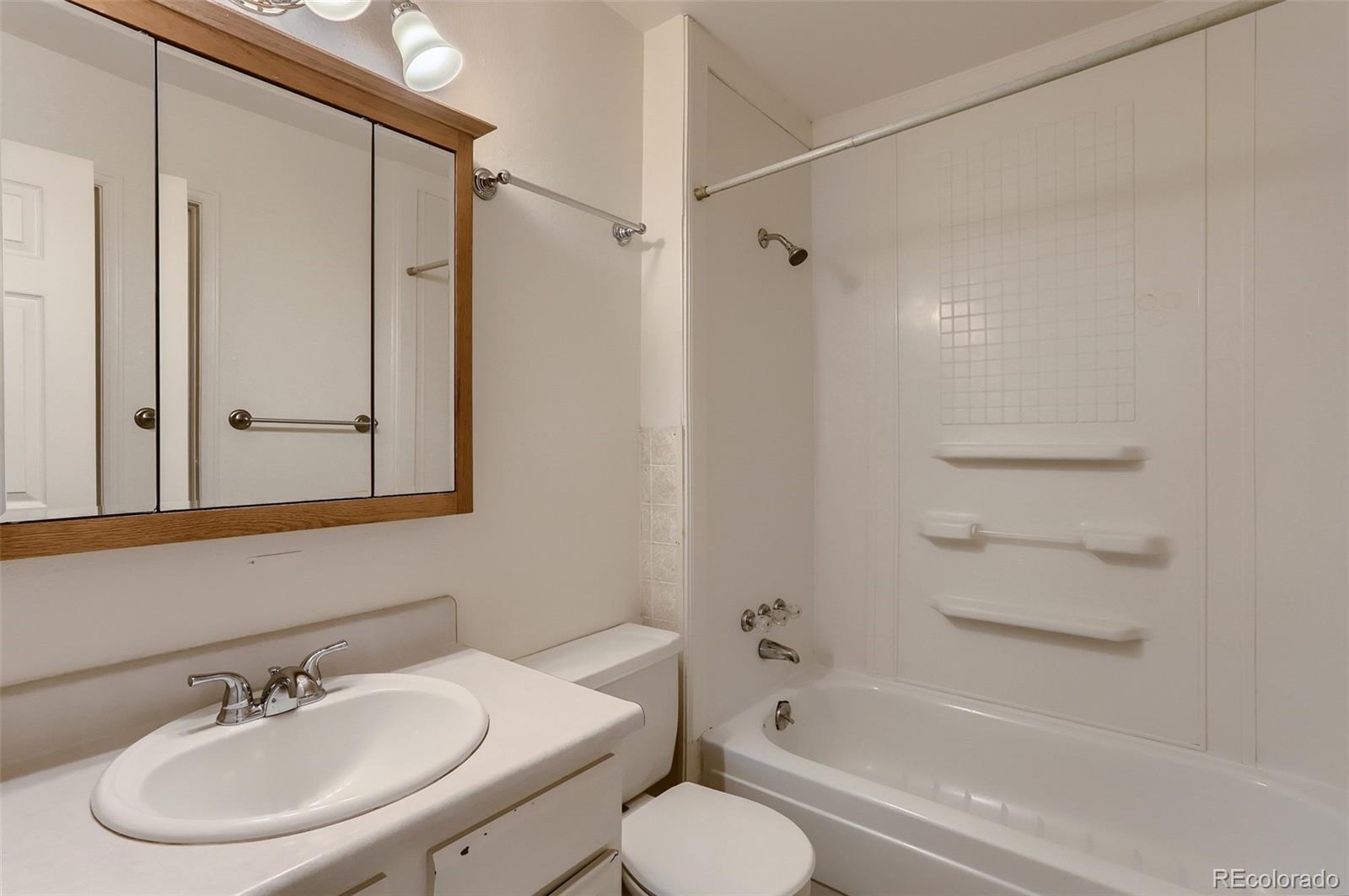 216 Summit Circle Lafayette, CO 80026 - Photo 15 of 31 a bathroom with a sink toilet and shower
