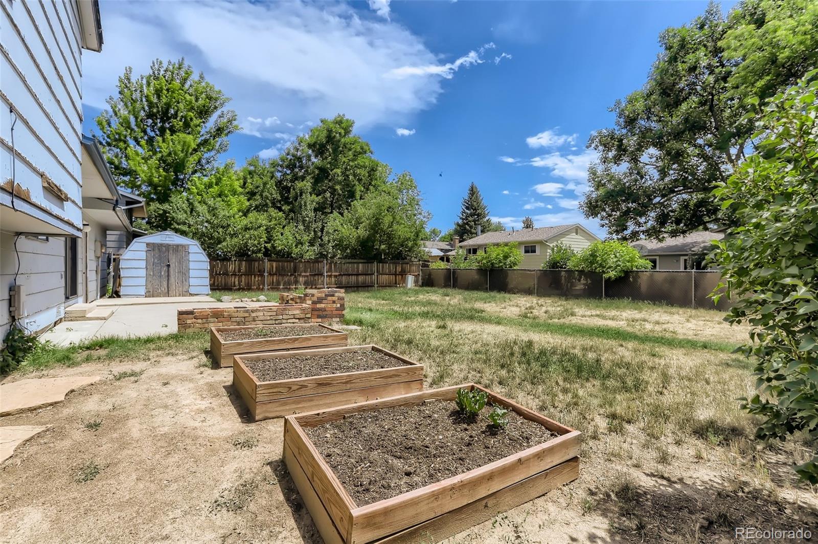 216 Summit Circle Lafayette, CO 80026 - Photo 24 of 31 a view of a yard with plants and a fountain