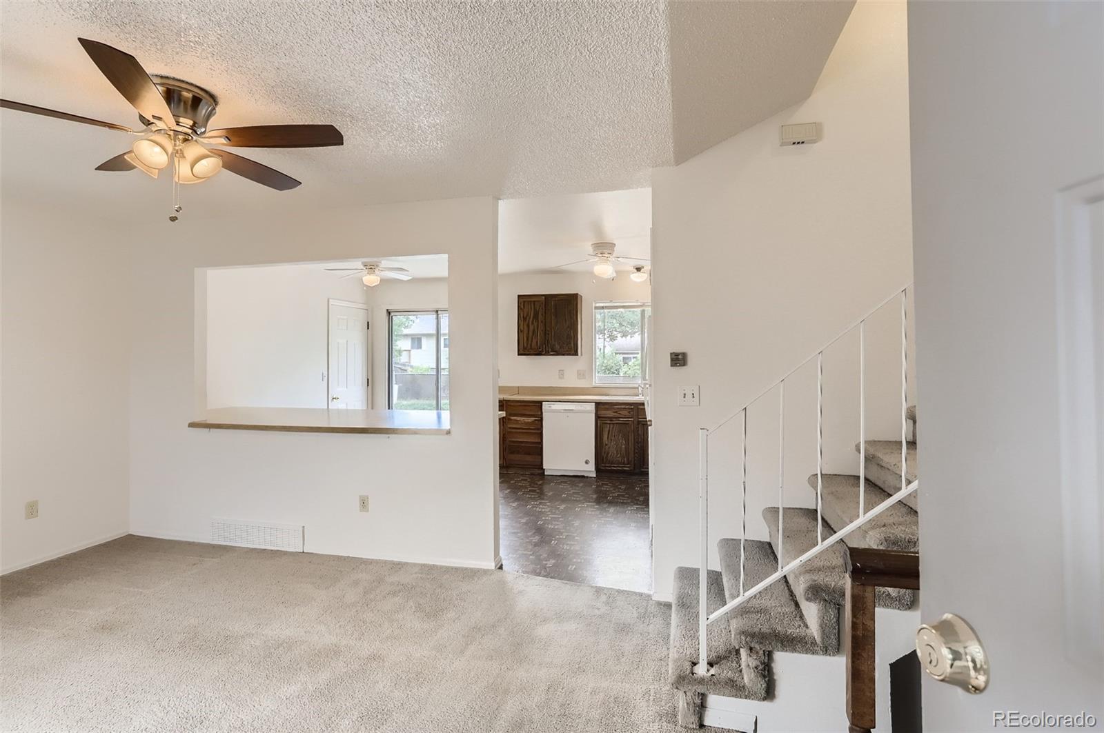 216 Summit Circle Lafayette, CO 80026 - Photo 4 of 31 a view of a livingroom with a staircase