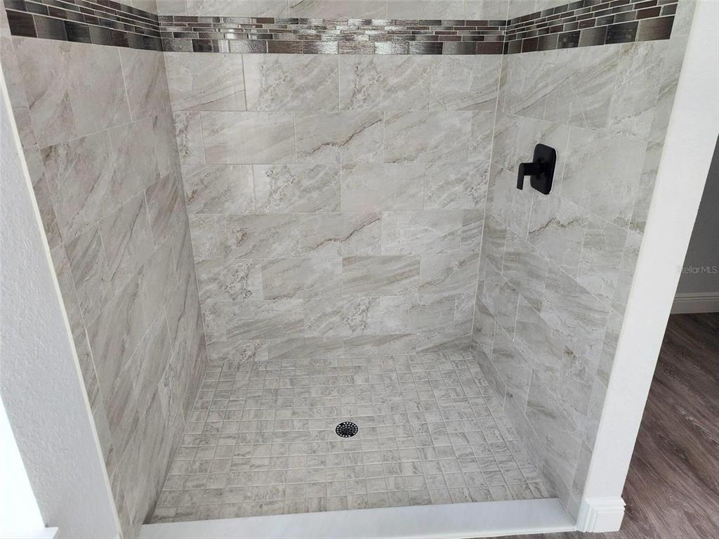 1111 Dagmar Avenue Spring Hill, FL 34606 - Photo 22 of 27 a bathroom with a shower