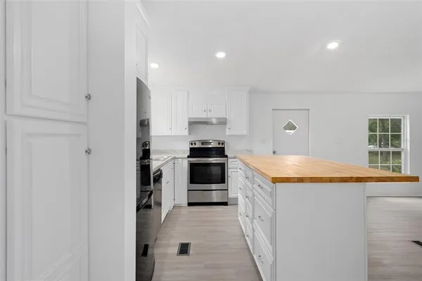 a kitchen with granite countertop stainless steel appliances and counter space
