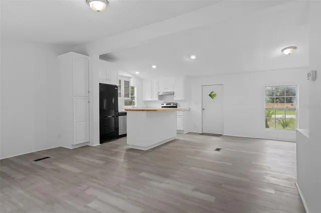 a view of kitchen with stainless steel appliances refrigerator oven and microwave
