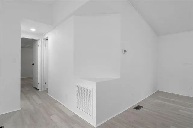 a view of hallway with wooden floor