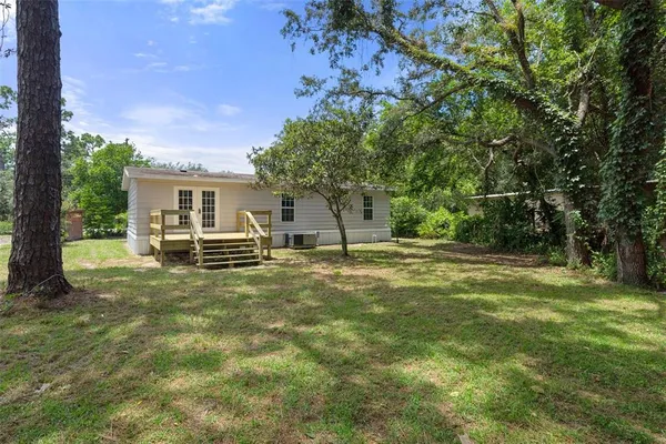a view of a house with a yard and garage