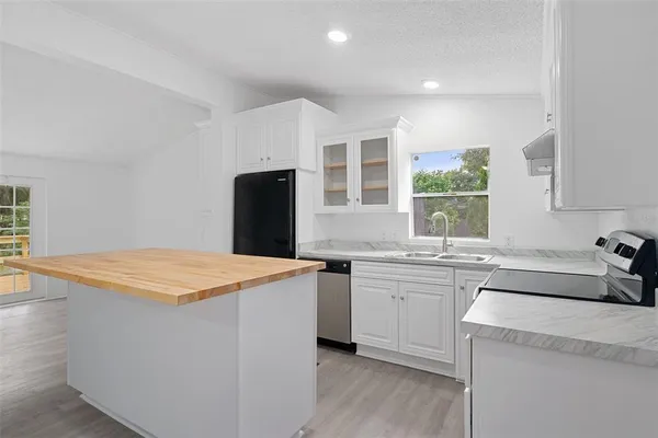 a kitchen with a sink a stove and a refrigerator