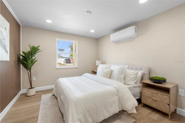 a bedroom with a bed and a potted plant