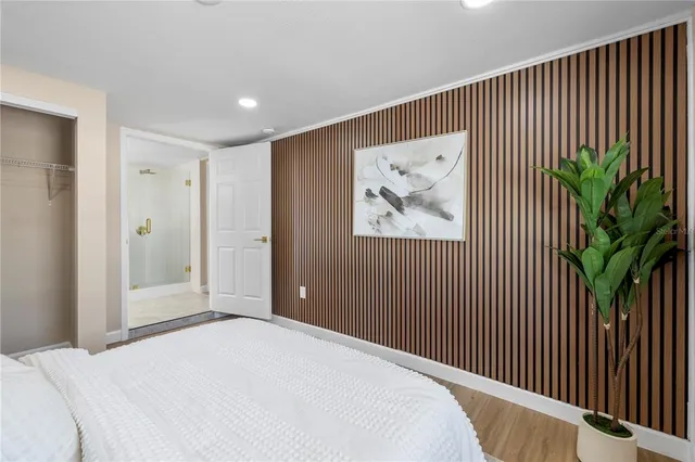 a bedroom with a bed and a painting on the wall