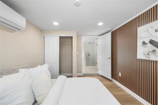 a bedroom with a large bed and a chandelier