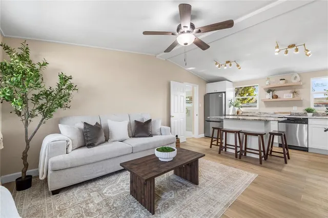 a living room with furniture and a wooden floor
