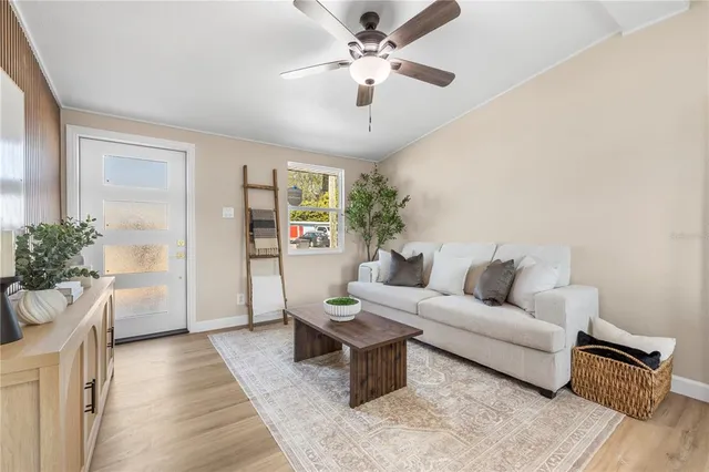 a living room with furniture and a chandelier
