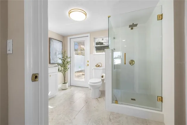 a bathroom with a shower and toilet