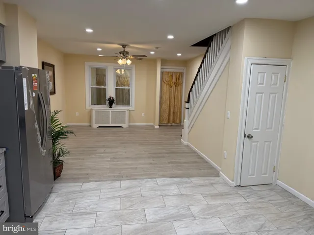 a view of a livingroom with furniture and stairs