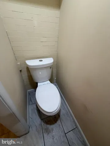 a bathroom with a sink toilet and mirror