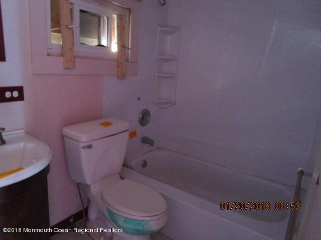 24 Sunset Road Brick, NJ 08723 - Photo 12 of 15 a white toilet sitting next to a bath tub