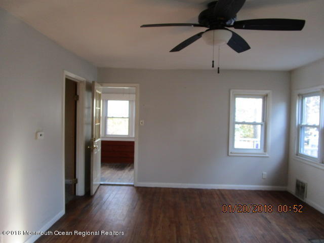 24 Sunset Road Brick, NJ 08723 - Photo 7 of 15 an empty room with wooden floor and windows