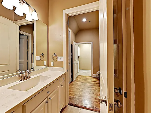 a spacious bathroom with a sink and a mirror