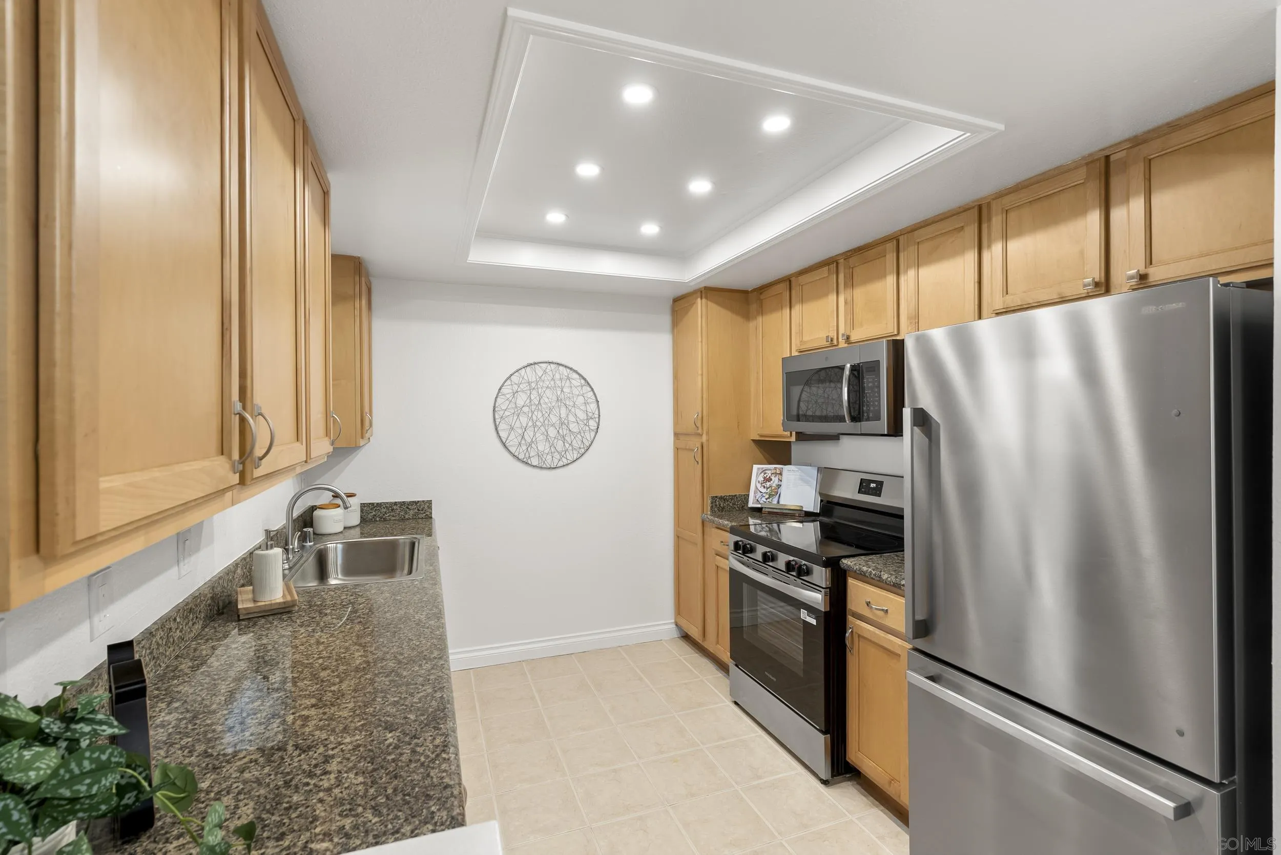 830 Broadway, Unit 15 El Cajon, CA 92021 - Photo 13 of 21 a kitchen with stainless steel appliances granite countertop a refrigerator a stove and a sink with large window