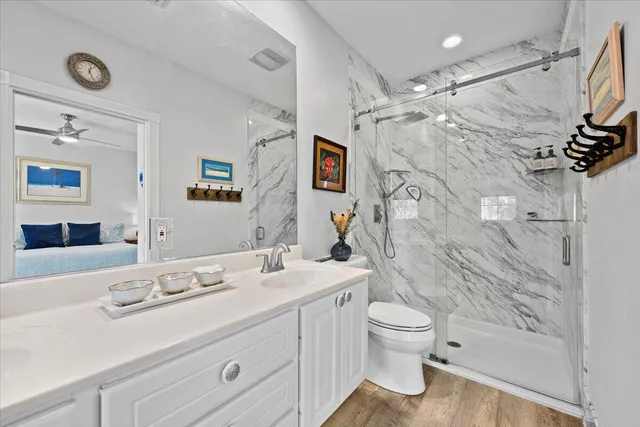 a bathroom with a sink a toilet and mirror