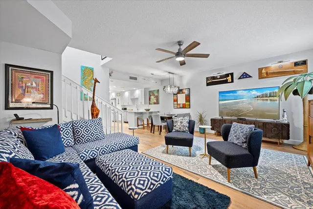 a living room with furniture and a chandelier