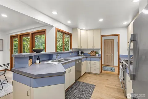 a kitchen with a stove a sink and a refrigerator