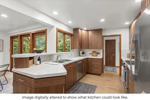 a kitchen with stainless steel appliances granite countertop a stove a sink dishwasher and a refrigerator