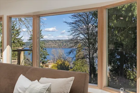 a view of a porch with furniture and floor to ceiling window