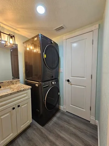 a bathroom with a granite countertop toilet sink and mirror