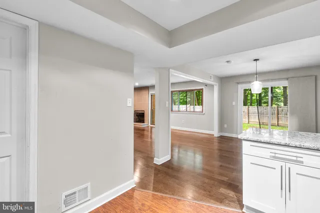 a open kitchen with granite countertop a refrigerator and a sink