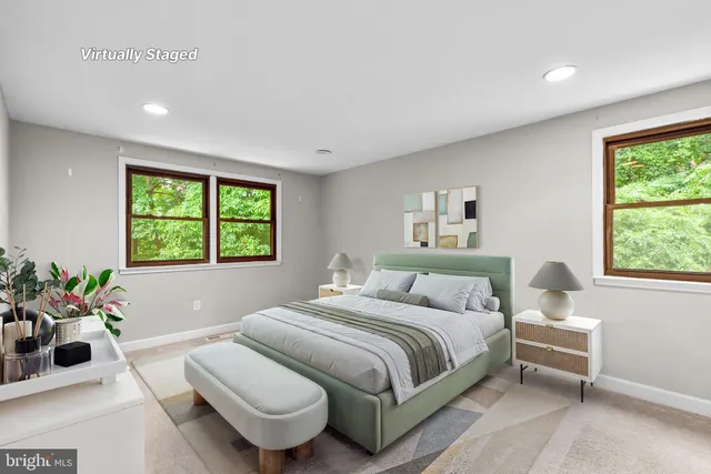 a bedroom with a bed and a large window